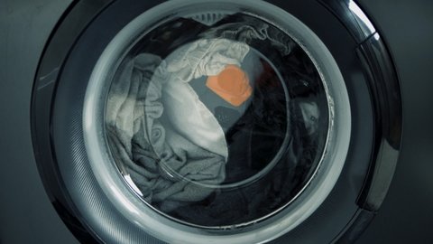 Washing machine in the process, wash clothes in the washing machine, close-up of cleaning clothes.