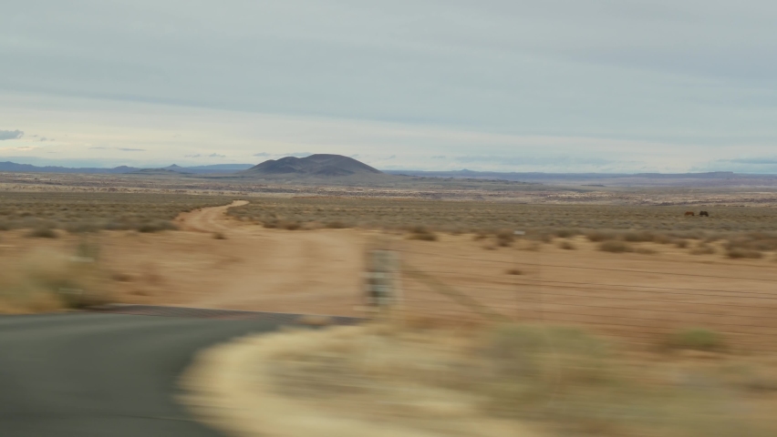 Road trip to Grand Canyon, Arizona USA, driving auto from Utah. Route 89. Hitchhiking traveling in America, local journey, wild west calm atmosphere of indian lands. Colorado plateau from car window. Royalty-Free Stock Footage #1064705344