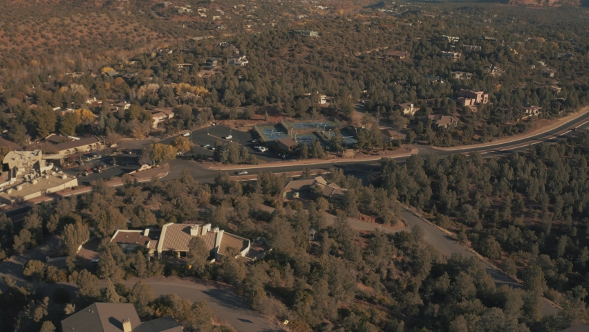 Aerial Drone View of residential areas and roads in Sedona and Oak Creek Canyon in Red Rock Country in Arizona on a bright and sunny fall day showing the unique red rock formations and landscapes 