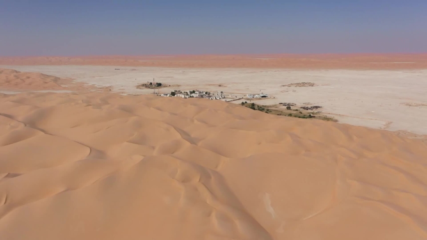 village behing the sand in oman desert