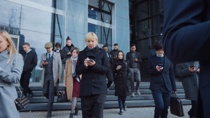 Successful Group of Interconnected Business People Walking Street using Smartphone Sending Data Up into the World Wide Connected Social Network. Diverse People Use Internet to do E-Business Royalty-Free Stock Footage #1064717989