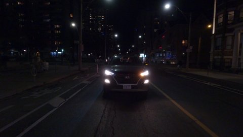 Toronto, Ontario, Canada December 2020 POV reverse night driving on quiet Toronto city streets during COVID 19 pandemic