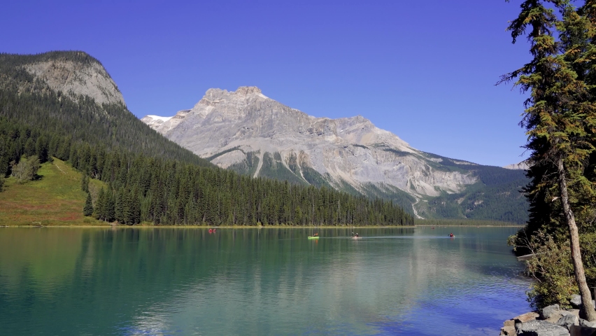 Canoeing on Emerald Lake in summer sunny day. Yoho National Park, Canadian Rockies, British Columbia, Canada.