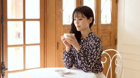 Young Asian woman relaxing in a cafe