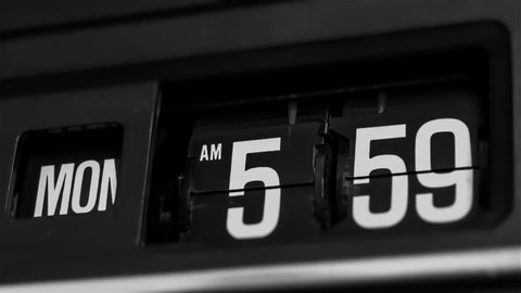 Retro flip clock changing from 5:59am to 6:00am on a Monday morning