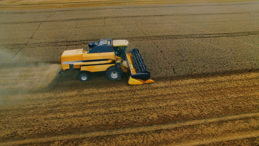 Aerial Shot: Harvester Working on Field. Digitalization of the Crops Growing Efficiency with AI Data Analysis Icons. Futuristic Agriculture Concept of Computerized, Eco, Sustainable way of Harvesting | Shutterstock HD Video #1064754874