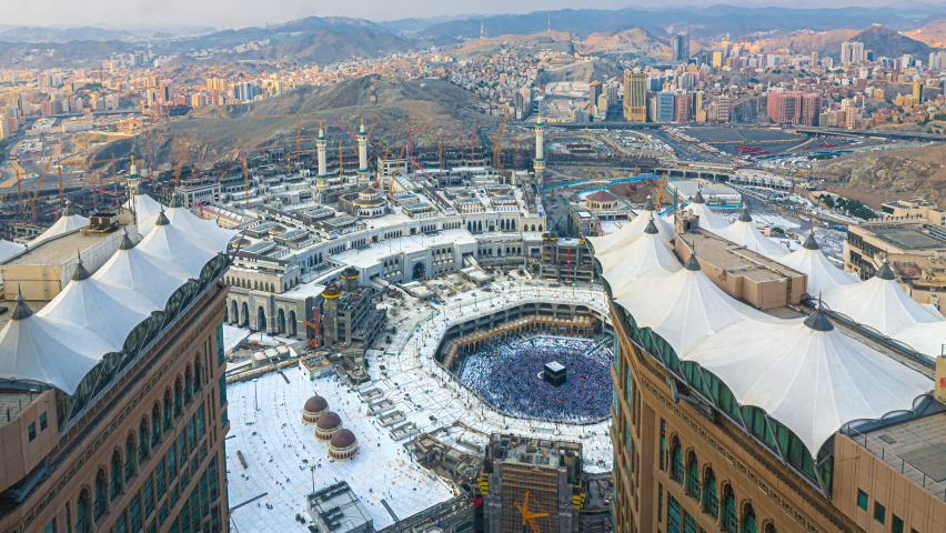 Time lapse wide angle of Muslim pilgrims circling around the holy Kaaba at day and praying inside al Masjid al Haram in Mecca, Saudi Arabia. Prores 4K Royalty-Free Stock Footage #1064763163