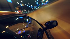 Side view of a car driving on the road along the street lamps with the lights reflection on a side mirror. Stock footage. Stop motion effect, night traffic.  - Powered by Shutterstock - Get 15% off with code: PIKWIZARD15