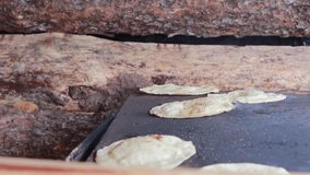 Authentic preparation of tortillas in traditional comal