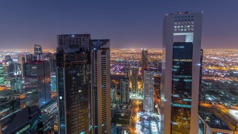 The skyline of the West Bay area from top in Doha timelapse, Qatar. Illuminated modern skyscrapers aerial view from rooftop at night before sunrise