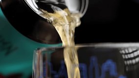 light foamy beer is poured into a glass from an aluminum can. foamy drink glistens in the light. cool drink is poured on black background in slow motion. 180 fps - Powered by Shutterstock - Get 15% off with code: PIKWIZARD15
