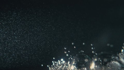 Video of underwater colorful bubbles rising to surface in slow motion 180fps. Close up, refreshing soda tonic fizzy water, bubbles dissolve in mineral carbonated drink. Bubbles particles rise up.