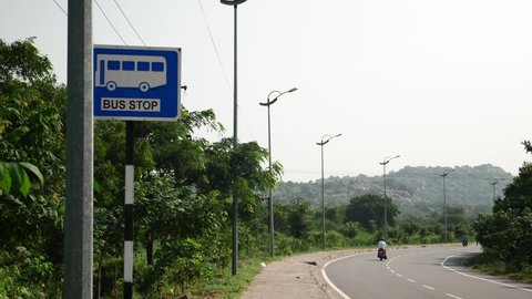 Bus stop sign along the road, passenger bus stop