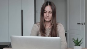 Tired caucasian woman working on laptop too long. Beautiful young millennial woman sitting from computer, breaking off work and massaging temples. Tiredness or headache concept.