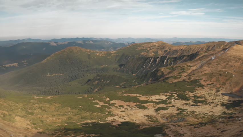 Burnt grass at mountain top aerial closeup. Nobody nature landscape. Environment scenery of brown burned moss at mount peak. Autumn sunny day. Cinematic Carpathians ridges, Ukraine, Europe