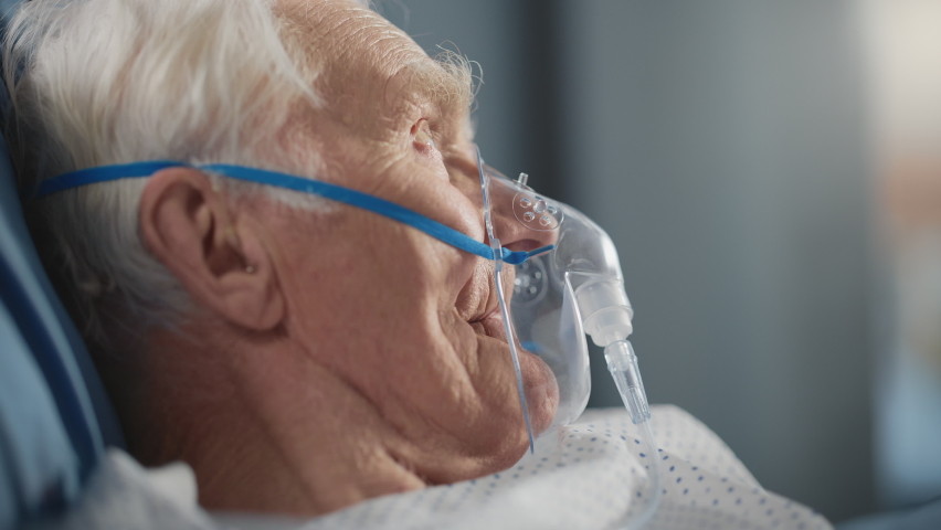 Hospital Ward: Portrait of Elderly Man Wearing Oxygen Mask Resting in Bed, Fully Recovering after Sickness and Successful Surgery. Old Man Remembering His Family, Friends, Happy Long Life Royalty-Free Stock Footage #1064810941