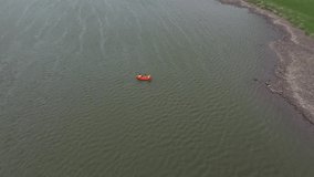 Flight through majestic river Dnestr with man on packraft orange rubber boat. Dniester canyon, Ukraine, Europe. Aerial UHD 4k drone video