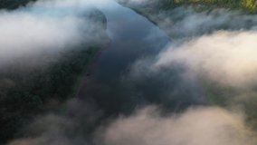 Flight through majestic foggy river Dnestr and lush green forest at sunrise time. Dniester canyon, Ukraine, Europe. Aerial UHD 4k drone video