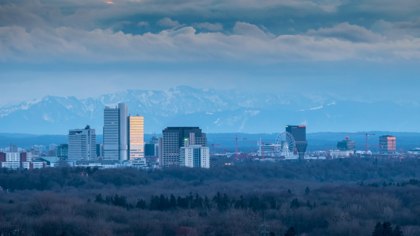 Munich cityscape skyscrapers time lapse at sunset in background alps mountins, munich skyline downtown view from top germany.