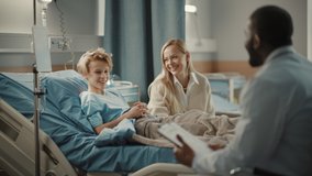 Hospital Ward: Handsome Young Boy Resting in Bed with Caring Mother Visits to Support Him, Friendly Doctor Talks, Gives Advice. Happy Smiling Patient Recovering after Sickness or Successful Surgery - Powered by Shutterstock - Get 15% off with code: PIKWIZARD15
