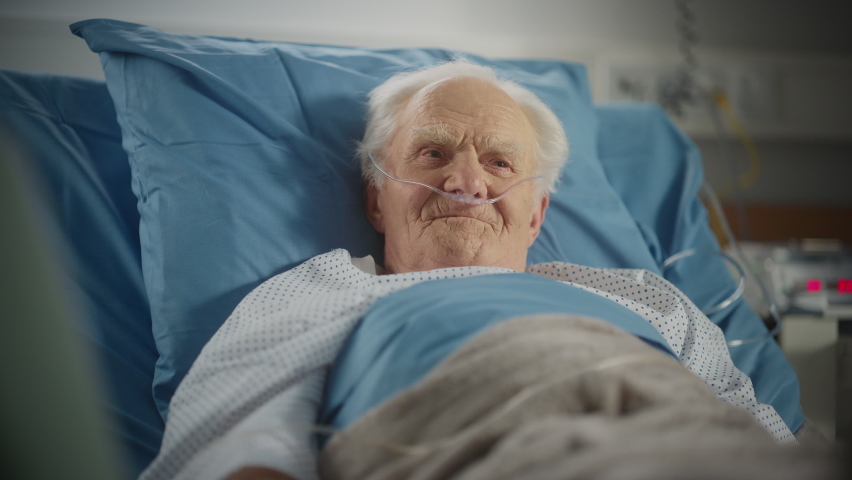 Hospital Ward: Portrait of Elderly Man Resting in Bed, Fully Recovering after Sickness and Successful Surgery. Old Man thinking about His Happy Long Life, Remembering His Family, Friends Royalty-Free Stock Footage #1064816758