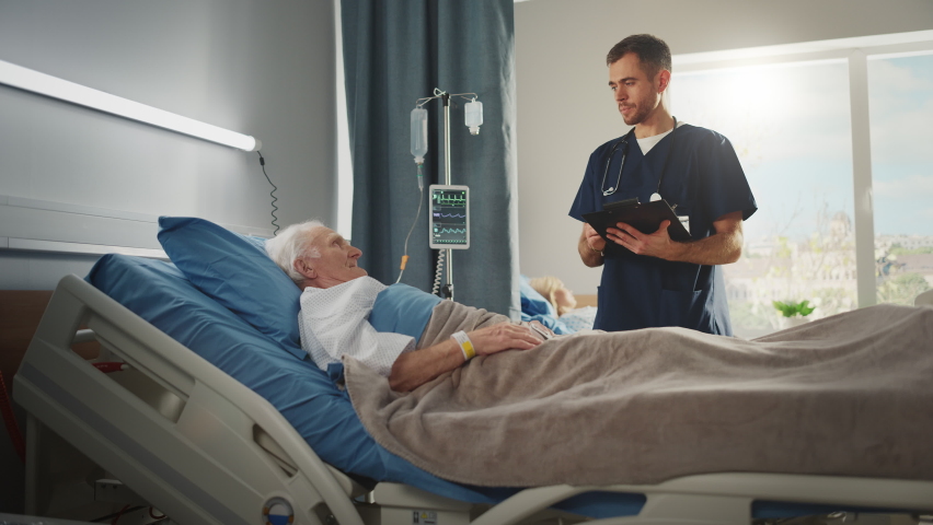 Hospital Ward: Friendly Male Nurse Talks with Elderly Patient Resting in Bed. Doctor Uses Tablet Computer, Does Checkup. Old Man Fully Recovering after Successful Surgery. Modern Bright Clinic | Shutterstock HD Video #1064816821