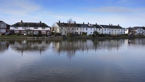 Beautiful Slipper Mill Pond in Emsworth with reflections in the water of cottages and houses along the far side.