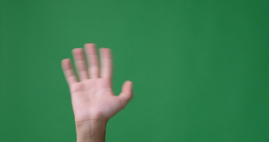 Hand waving and gesturing hello over green screen Royalty-Free Stock Footage #1064837128