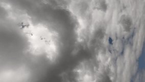 Large cumulus clouds in the blue summer sky. Timelapse. Cloudy sky as background. Vertical video.
