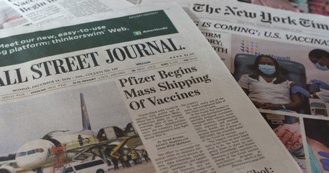 New York, New York  United States - December 14,  2020: Newspaper coverage, Pfizer begins mass shipping of Covid-19 vaccine. Headlines, picture, articles.