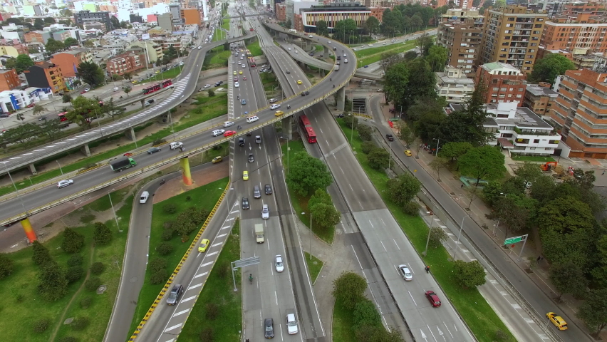 Aerial view of traffic on major intersection in Bogota, the capital and largest city of Colombia, South America. Urban infrastructure, transportation and development concept. Royalty-Free Stock Footage #1064863024
