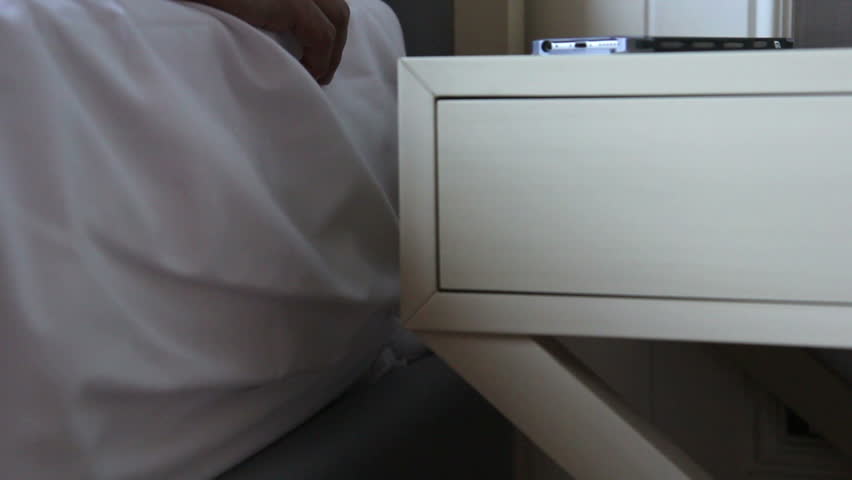 Man hangover after party and try to wakes up in the morning with calling from smart phone