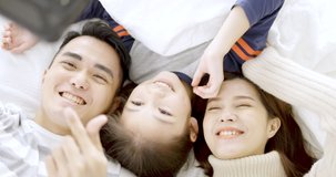  Happy family  and daughter Lying in bed and making selfie