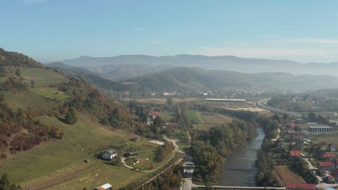 
Aerial view of Bosnia and Herzegovina. Drone video of a mountain landscape, with villages in which there are houses of kulitsa and roads that surround the mountains with forests and mountain ranges.