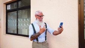 Senior hipster man with tatoo caling and having fun with a phone, happiness, technology and elderly lifestyle people concept