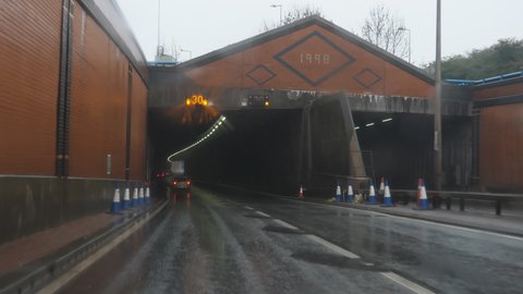 STOKE-ON-TRENT, ENGLAND, UNITED KINGDOM - CIRCA NOVEMBER, 2020: Car driver view driving inside Meir Tunnel on Uttoxeter Road in wet weather.
