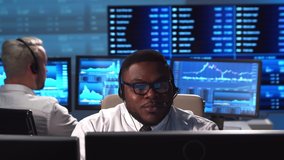 Diverse team of brokers workin in office using workstation and analysis technology. Workplace of professional traders. Global financial markets, business, currency exchange and banking concepts. - Powered by Shutterstock - Get 15% off with code: PIKWIZARD15