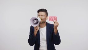 Cheerful bearded man in business suit paying attention announcing big sale yelling at loudspeaker, black Friday shopping. Indoor studio shot isolated on gray background - Powered by Shutterstock - Get 15% off with code: PIKWIZARD15