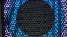 An acoustic speaker that shimmers with different colors. The camera shoots close up and moves smoothly in different directions