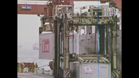 1970s: cranes lift shipping containers onto boats at dock, group of logs lifted over dock, crane drops pile of ore into truck bed
