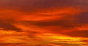 Sun setting sky epic time lapse. Vivid red orange light timelapse video footage clip. Gloaming sundown spectacular skyscape background. Fantastic clouds rolling heaven high speed motion, fly movement