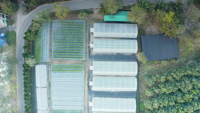 Agricultural research institutes and greenhouse building. Include soil plot, plant, plantation in field. To studying, testing, improving crop and development with  science, technology. In aerial view. | Shutterstock HD Video #1064895982