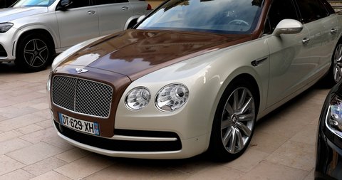 Monte-Carlo, Monaco - January 2, 2021: White And Brown Bentley Flying Spur Luxury Car Parked In Front Of The Monte-Carlo Casino In Monaco On The French Riviera, Europe - DCi 4K