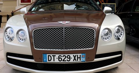Monte-Carlo, Monaco - January 2, 2021: Closeup View Of A White And Brown Bentley Flying Spur Luxury Car Parked In Front Of The Monte-Carlo Casino In Monaco On The French Riviera, Europe - DCi 4K