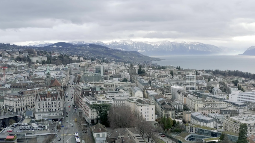 Drone Aerial of Lausanne located at the lake geneva in winter during the holiday season. The scenic lac lehman shows reveals the mountain landscape on the french side of the lake. Switzerland, Europe.