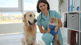 Golden retriever dog licking veterinarian with cat in hands in veterinary clinic - Powered by Shutterstock - Get 15% off with code: PIKWIZARD15
