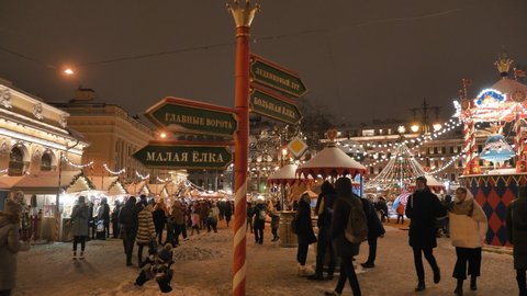 RUSSIA, ST. PETERSBURG, DECEMBER 26, 2020. Crowds of people walk at the new year's Christmas market in the city center along the stalls with Souvenirs and street food, buy gifts for the new year