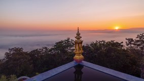 Time lapse of sunrise with fog at Wat Phra That Doi Phra Chan temple on the top hill of Doi Phra Chan mountain in Mae Tha district, Lampang province, Thailand.