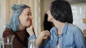 Handheld video of lesbian couple in love during breakfast. Shot with RED helium camera in 8K.
