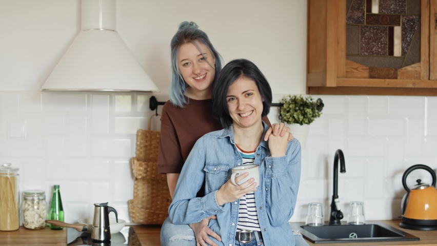 Portrait video of happy lesbian couple in the kitchen. Shot with RED helium camera in 8K.